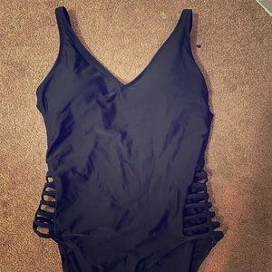 A black swimsuit with details on the sides
